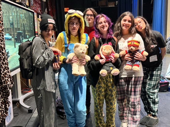 Behind the stage with pajamas and teddy bears. 